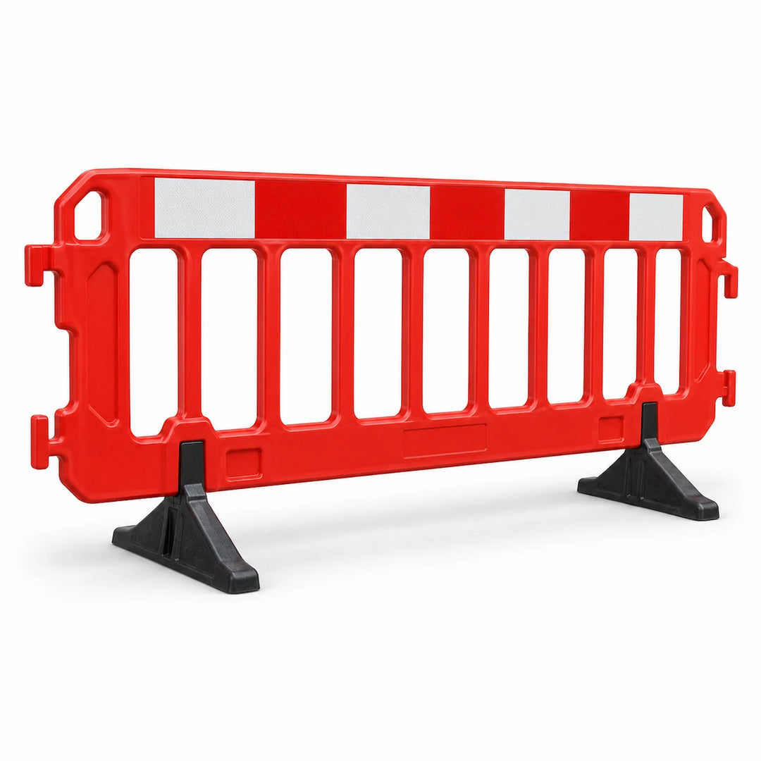 Red pedestrian safety barrier with reflective panels and support feet on a white background